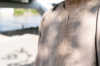 Caramel Linen thobe — neckline detail outdoors