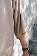 Caramel Linen thobe — sleeve detail outdoors