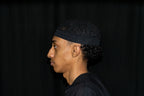 Charcoal Kufi prayer cap — left side view
