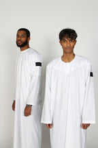 Bleached Emirati thobe — two-model studio view